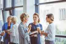 Women talking during coffee break at convention center