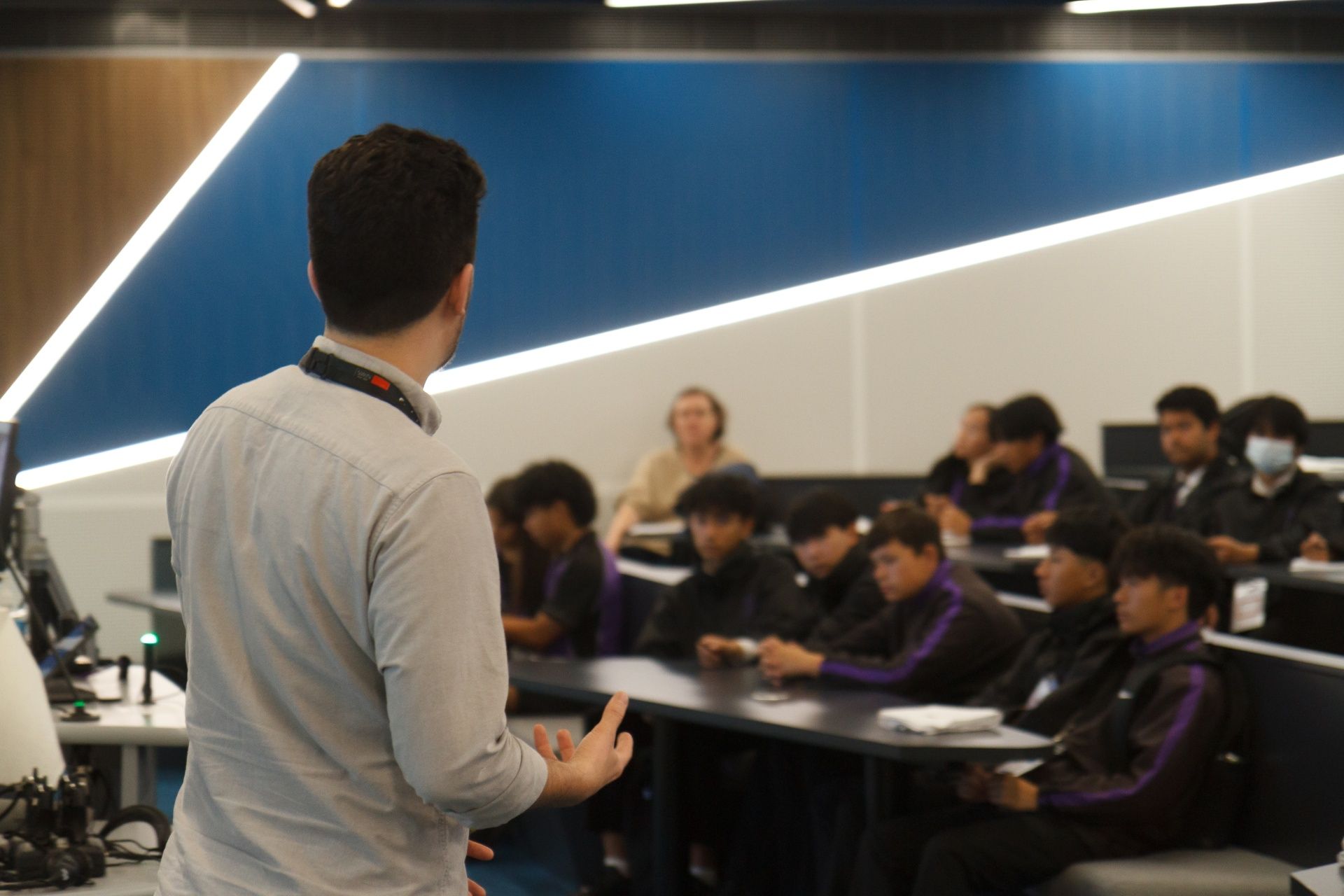 An academic presenting in front of students in a classroom