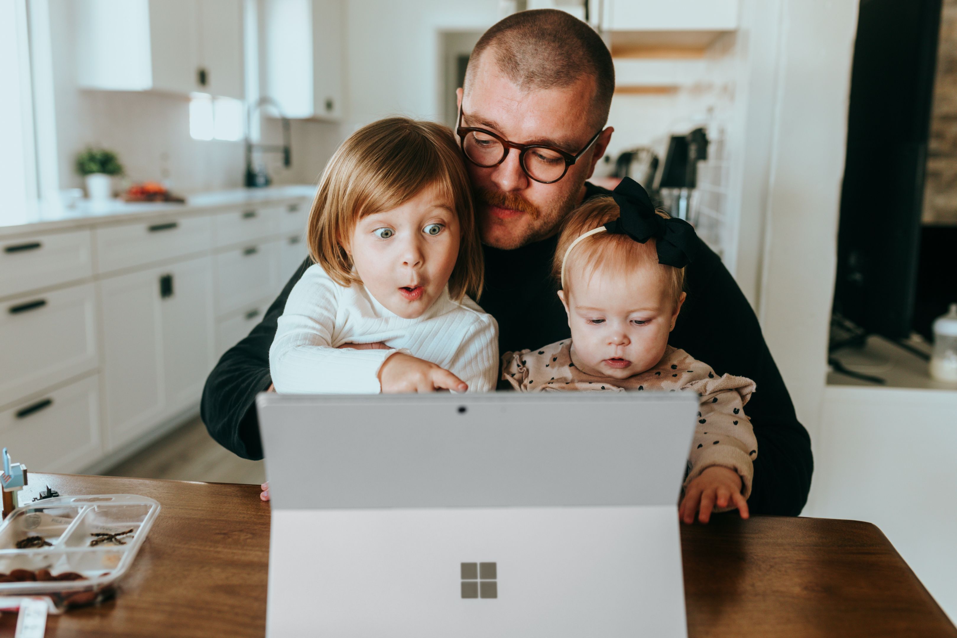 Man with his kids looking at laptop together 