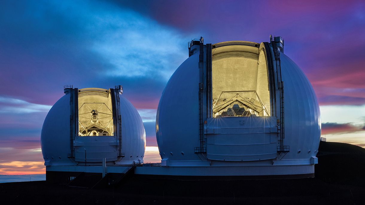 Twin telescopes of an observatory at sunset.
