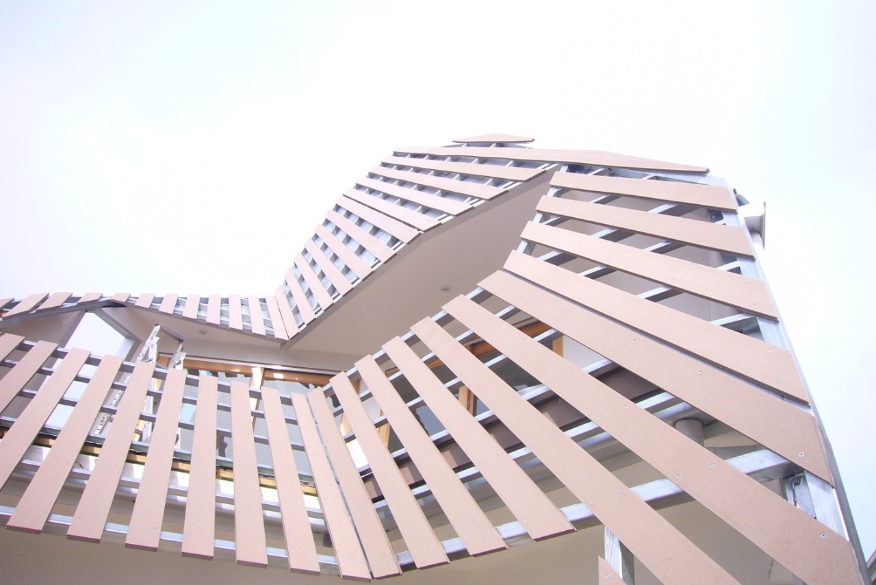 A computer-generated image showing a view looking up from the ground of a tall building's exterior.