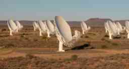 Long-range satellite dishes in a satellite farm