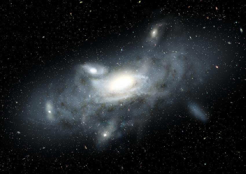 An artist’s impression of our Milky Way galaxy in its youth. Five small satellite galaxies, of various types and sizes, are in the process of being accreted into the Milky Way. The Sparkler galaxy provides a snapshot of an infant Milky Way as it accretes mass over cosmic time. 
