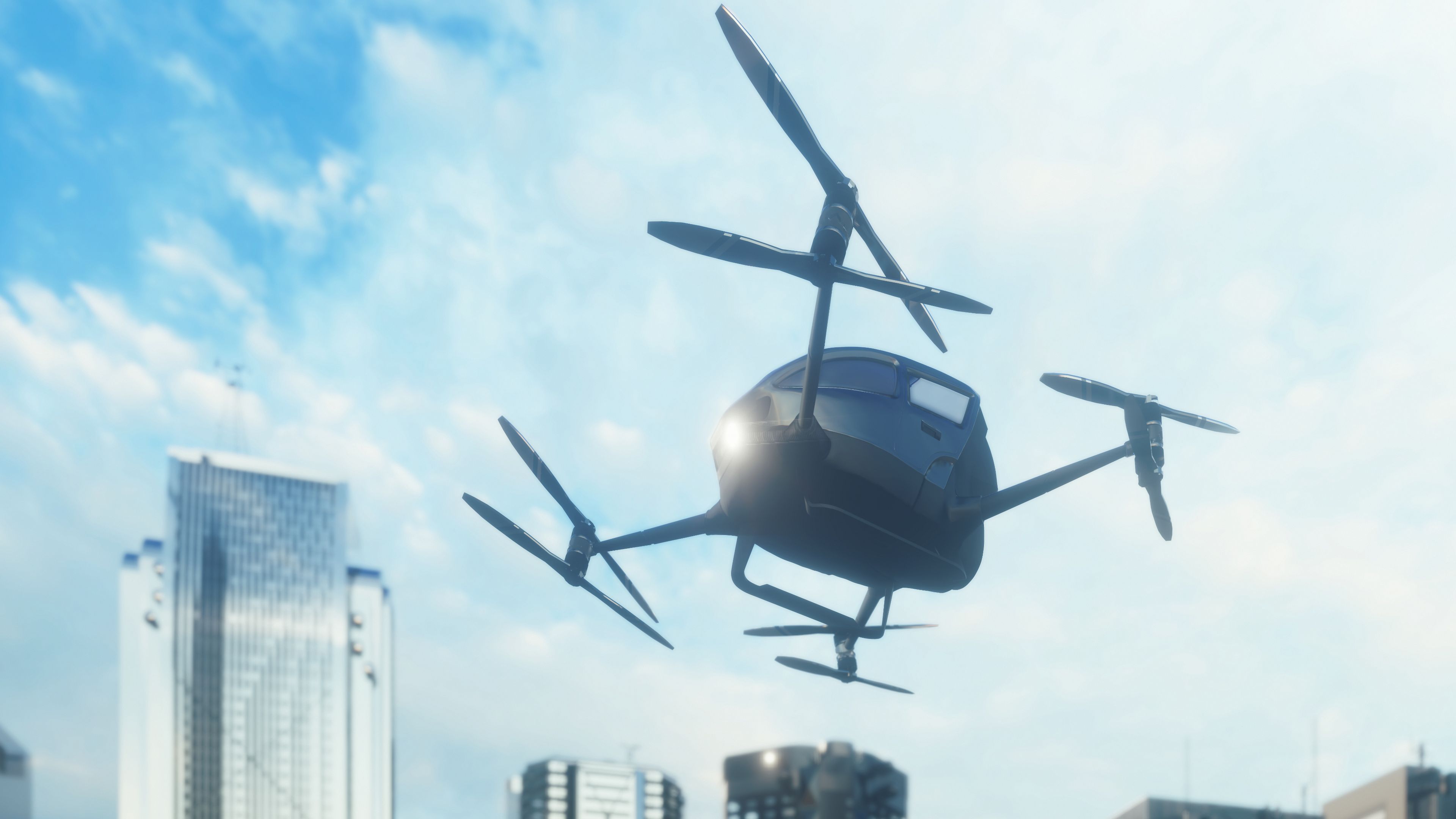 An unmanned passenger drone flying in city sky.