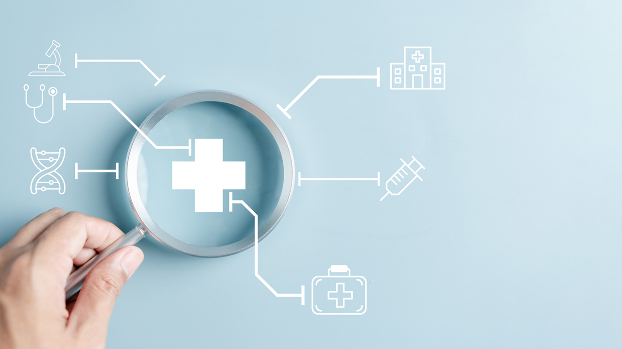 A magnifying glass positioned over a medical cross