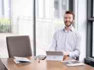 Swinburne young professional man laughing in boardroom