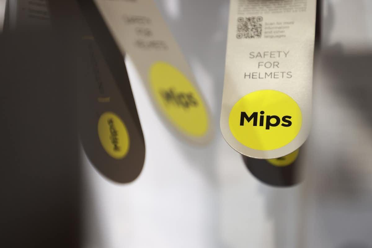 Helmet technology Mips tag hanging from a bike helmet in the store