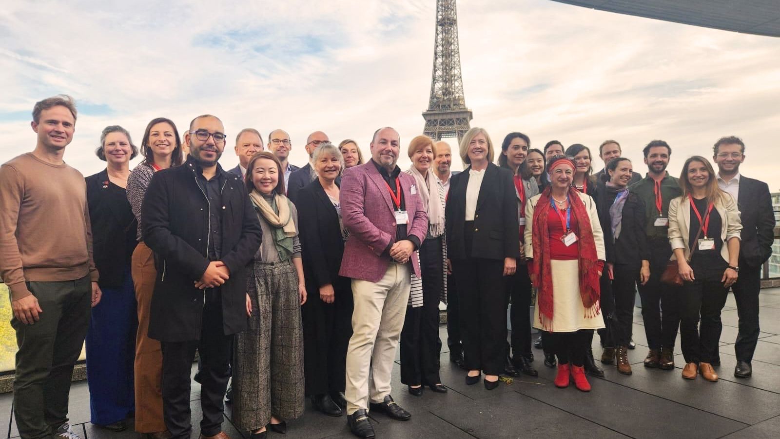 Large group of people with the Eiffel Tower in the background.
