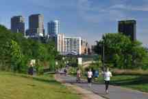 People walking and exercising in Schuylkill Banks Park in the center city of Philadelphia, Pennsylvania. 