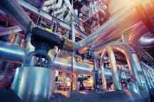 Equipment, cables and piping as found inside of a industrial power plant.