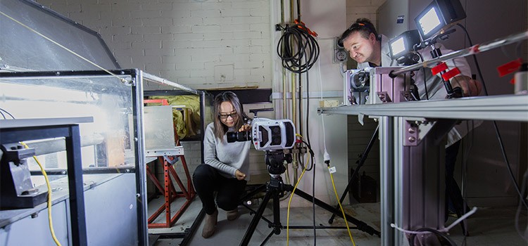 Two engineers using a high speed camera.