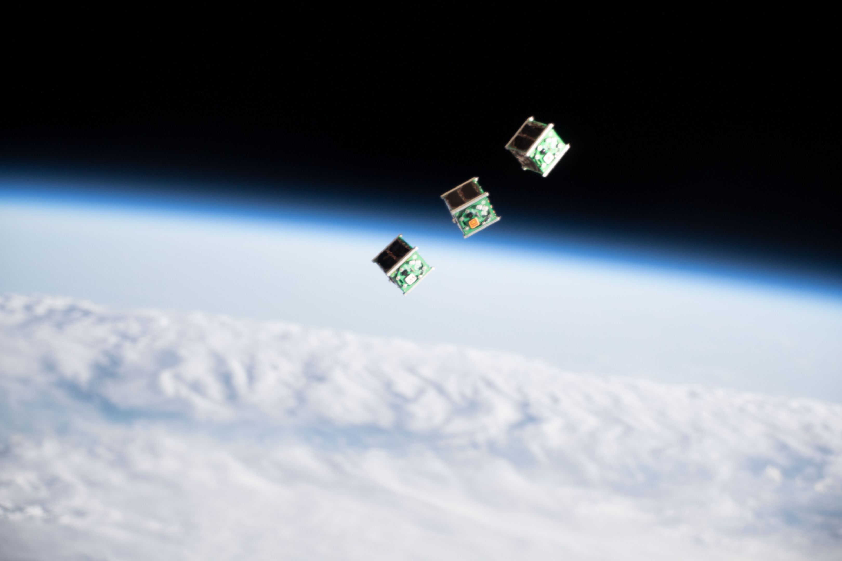Three CubeSats in space