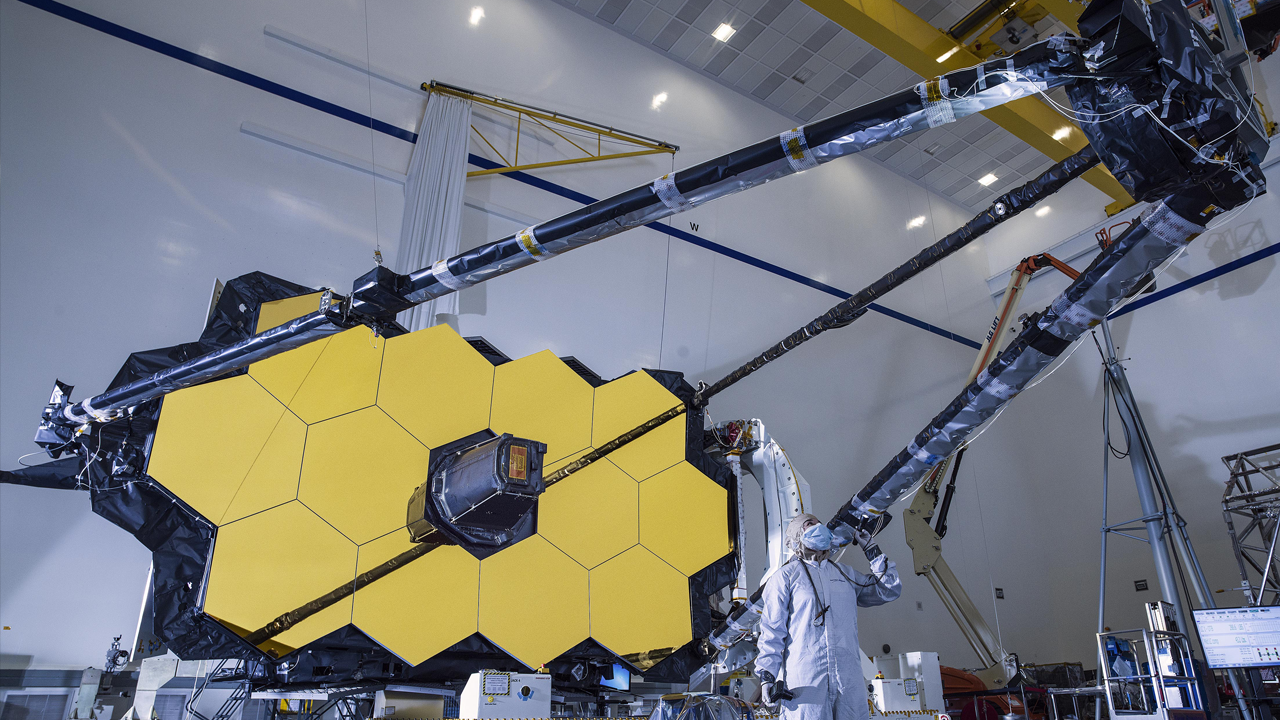 Technicians  visually inspect the support structure of the James Web Space Telescope.