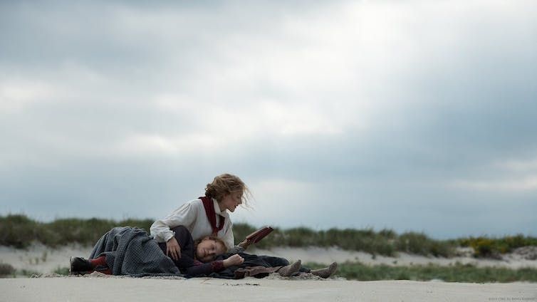 Little Women scene where they are reading on the beach