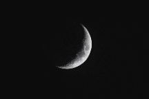 A crescent moon on a black sky