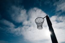 Netball goal ring and net against a blue sky and clouds at Hagley park, Christchurch, New zealand.