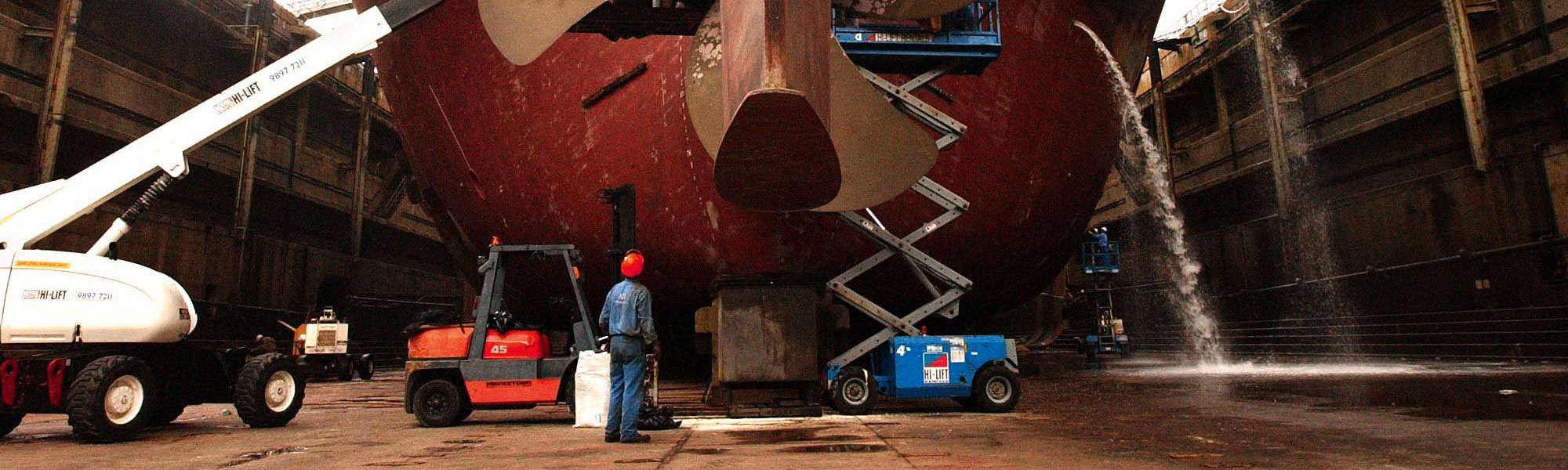 Large dry docked ship getting repairs
