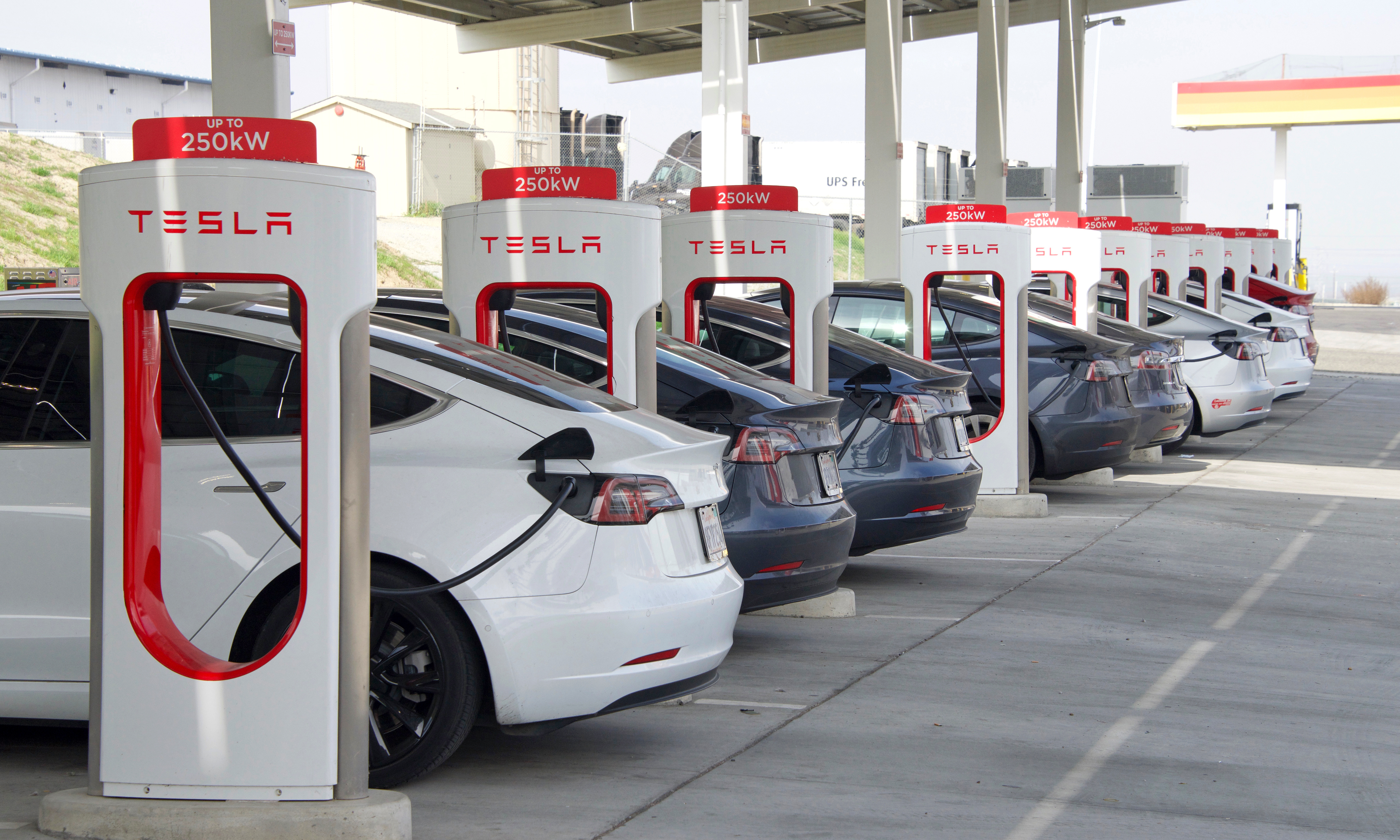 Kettleman City, CA - Jan 29, 2022: Many cars charging at a Tesla Supercharger station. Supercharger stations allow Tesla cars to be fast-charged at the network within a hour.