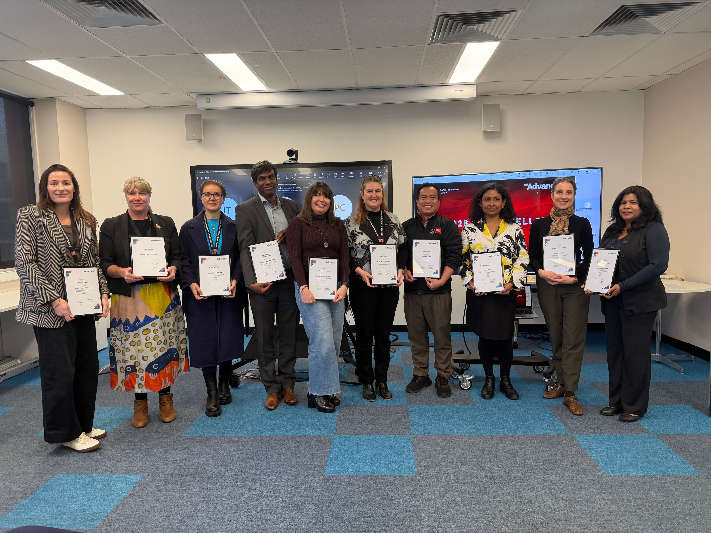 Group of Swinburne staff holding fellowship certificates
