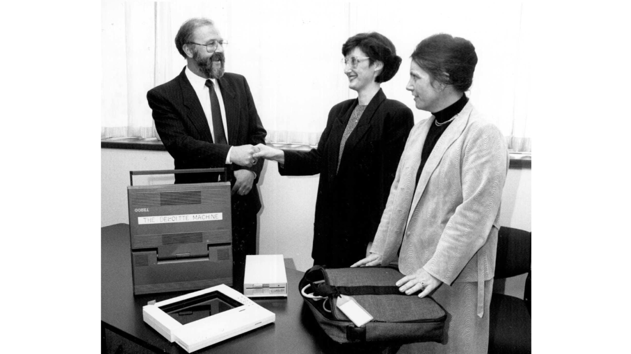 (Left to right) Bruce McDonald, Jan West and Ellen Sandercock from Deloitte donating a Toshiba T3200 Laptop computer for use in Faculty of Business, 1989.  