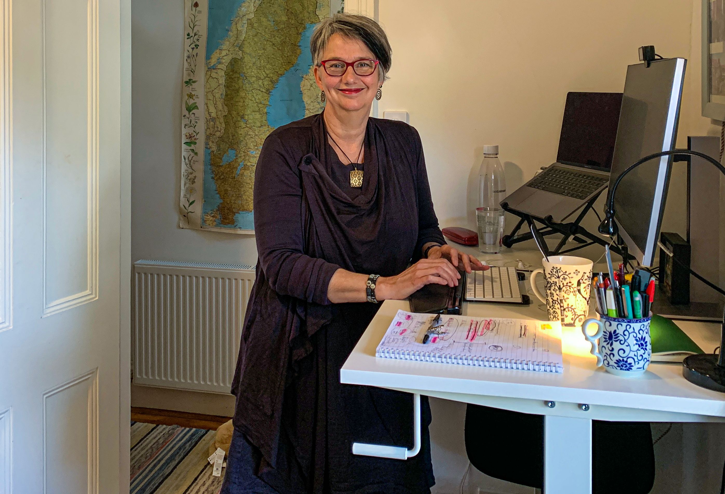 Professor Mia Lindgren at a standing desk and working. 