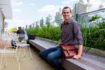 Brett sitting in the sky garden in the AMDC building on the Hawthorn campus