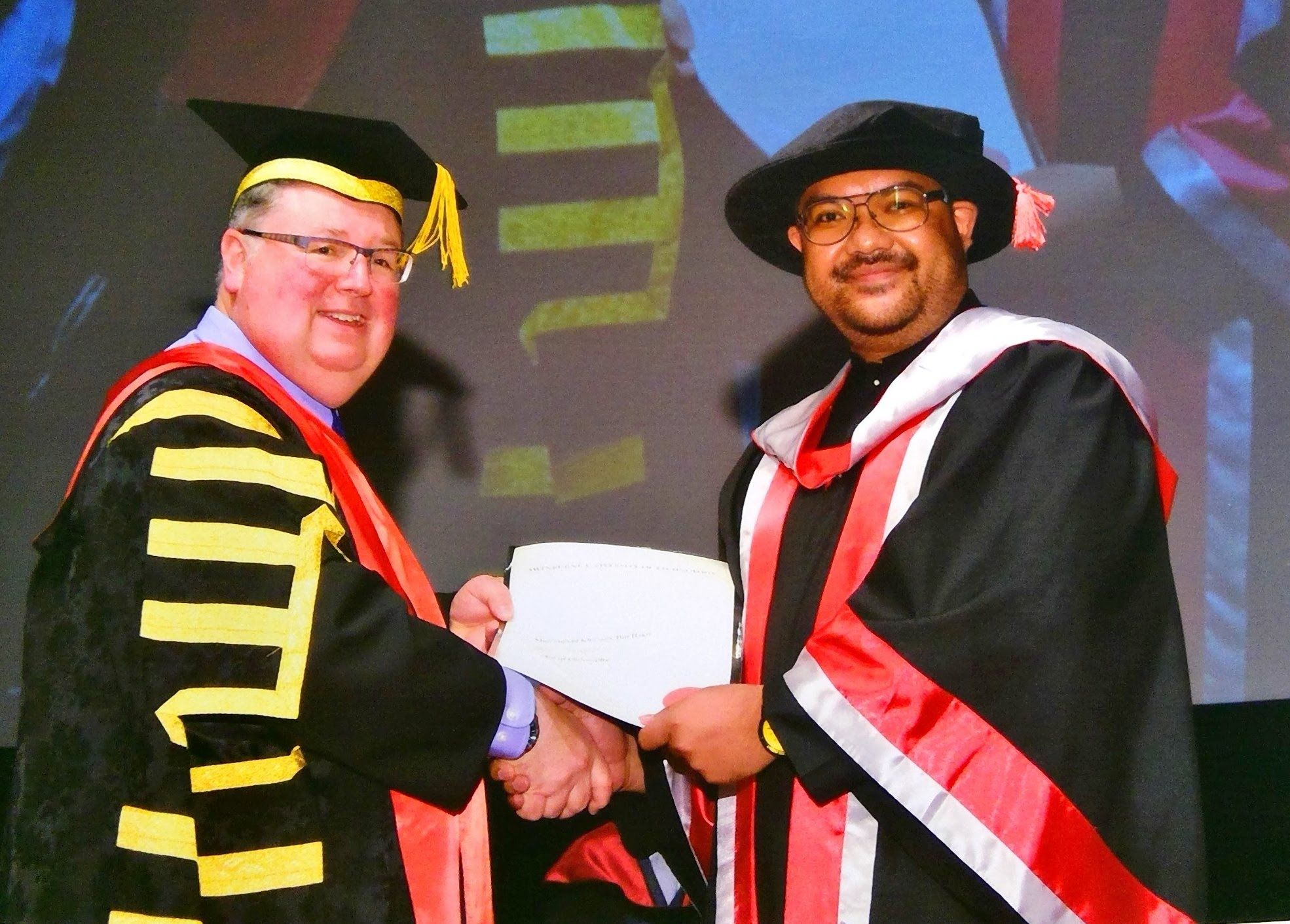 Dr Muhammad Khusair (Swinburne Sarawak Alumni) at his graduation ceremony, receiving his PhD & Master of Engineering. 