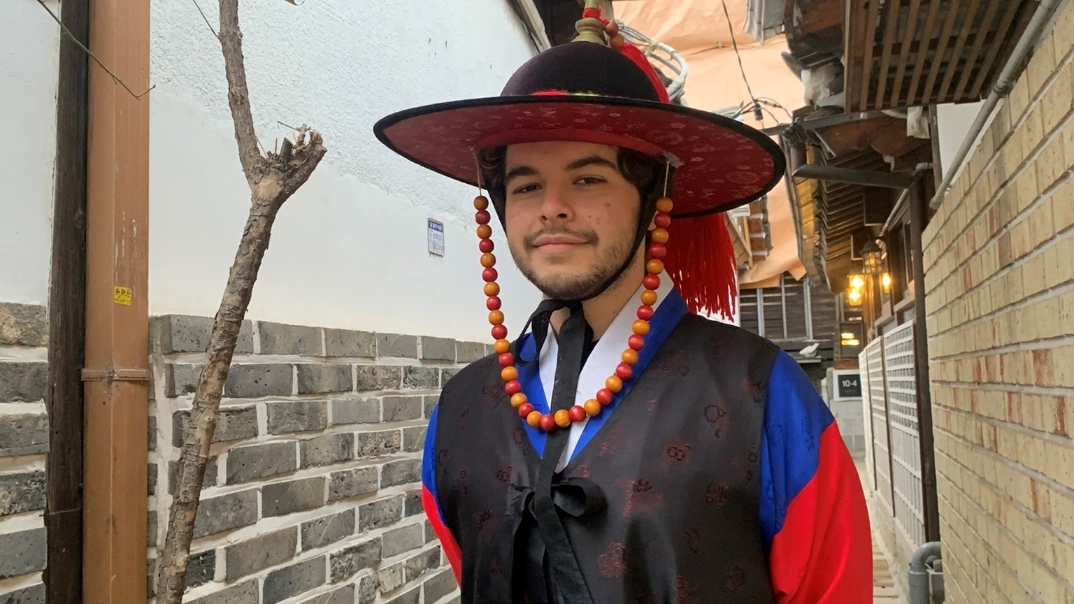 Man standing in alley in traditional dress