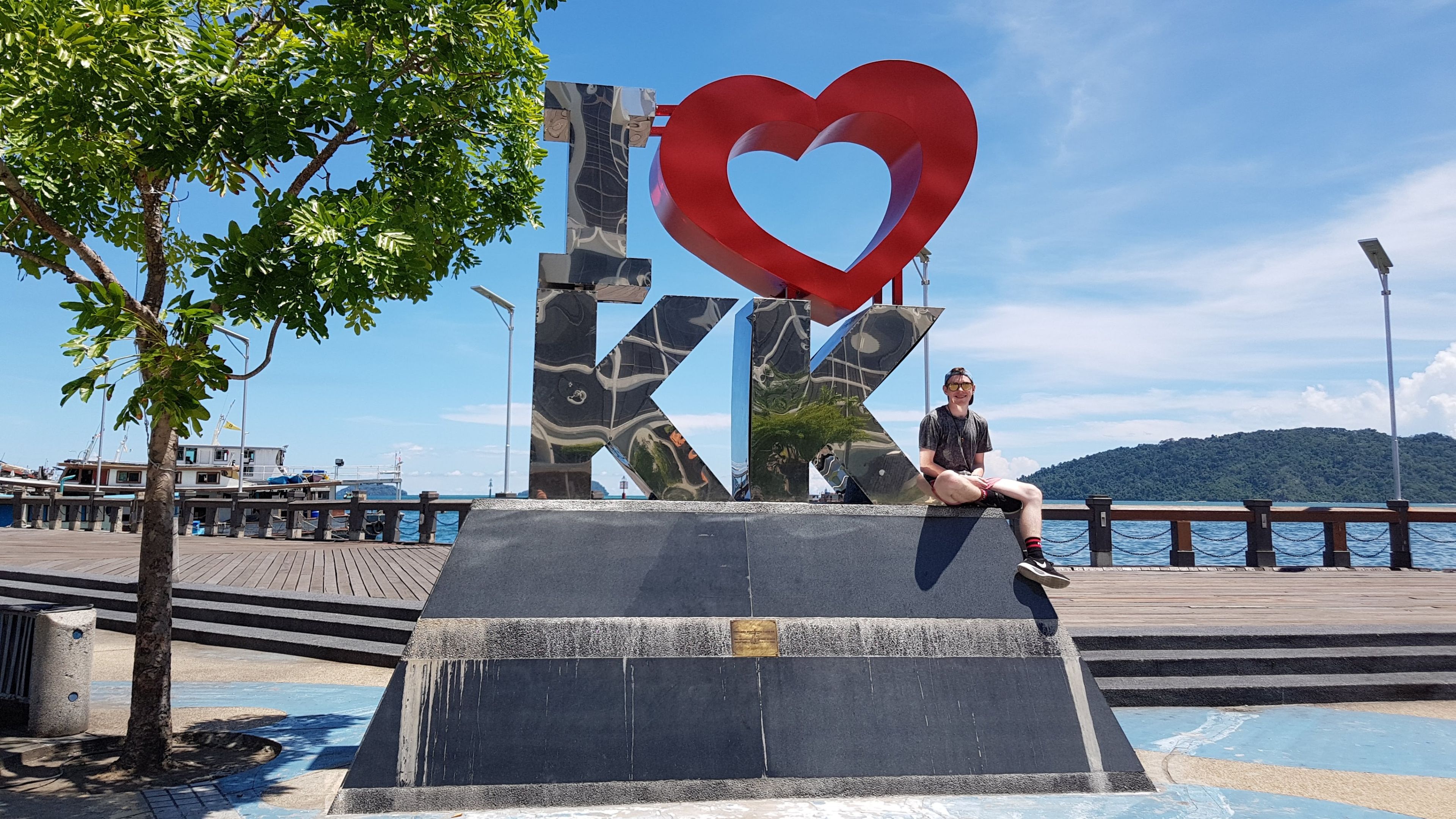 Josh is sitting on top of the I heart KK sculpture at the Kota Kinabalu waterfront in Sabah, Malaysia