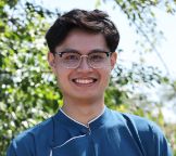 A portrait of a male student outside