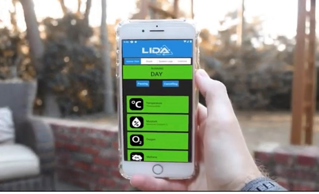 hand holding a mobile phone displaying the LIDA home composting app screen