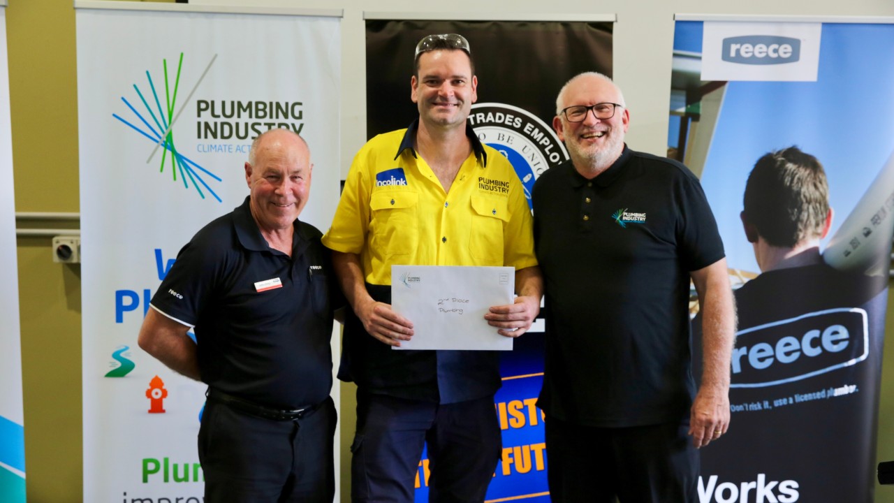 Swinburne student & 2nd prize winner Michael McDonald stands smiling in between John Doig and Shane La Combre. Michael is holding up his certificate