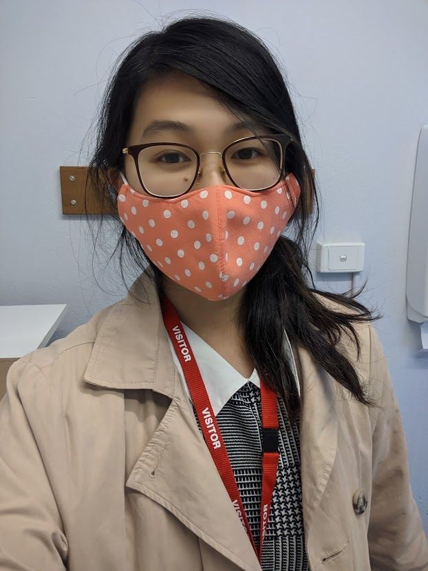 Student Funan Keith wears a face mask and a visitor pass while on her placement at a primary school during the pandemic