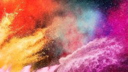Colourful powder (gulal) bursting in the air during Holi celebration