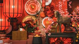 Lunar New Year decoration of a horse statue, lanterns, flowers and kitchenware