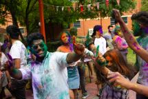 Students covered in colourful dye celebrate at a Swinburne event on Hawthorn campus