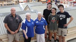 Croydon Rotary, Swinburne VET students and staff are all standing in front of flatpacked tool sheds ready for transportation