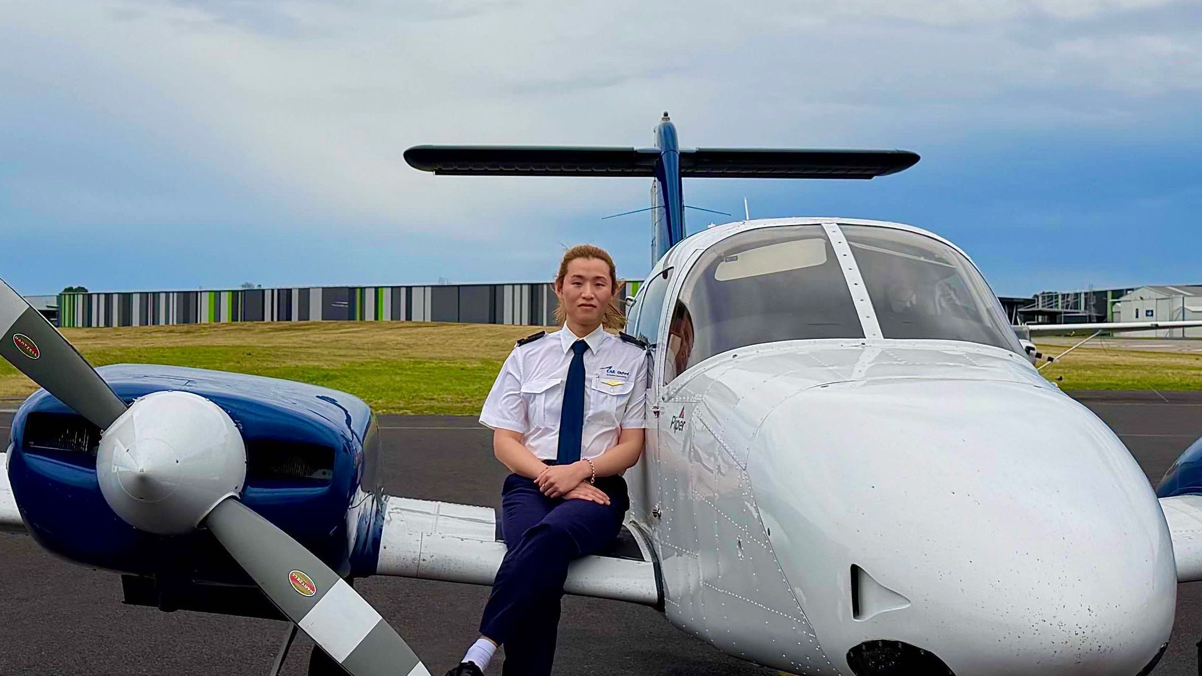 Woman outside witting on a small jet plane 