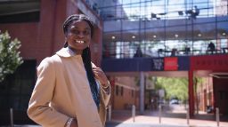 Young woman smiling standing outside