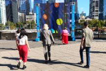 Students are looking at the open arcade exhibition in Southbank Melbourne