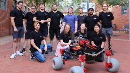 Students standing outside with their rover