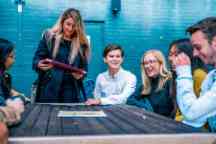 Students sitting at a wooden table outside in Hawthorn