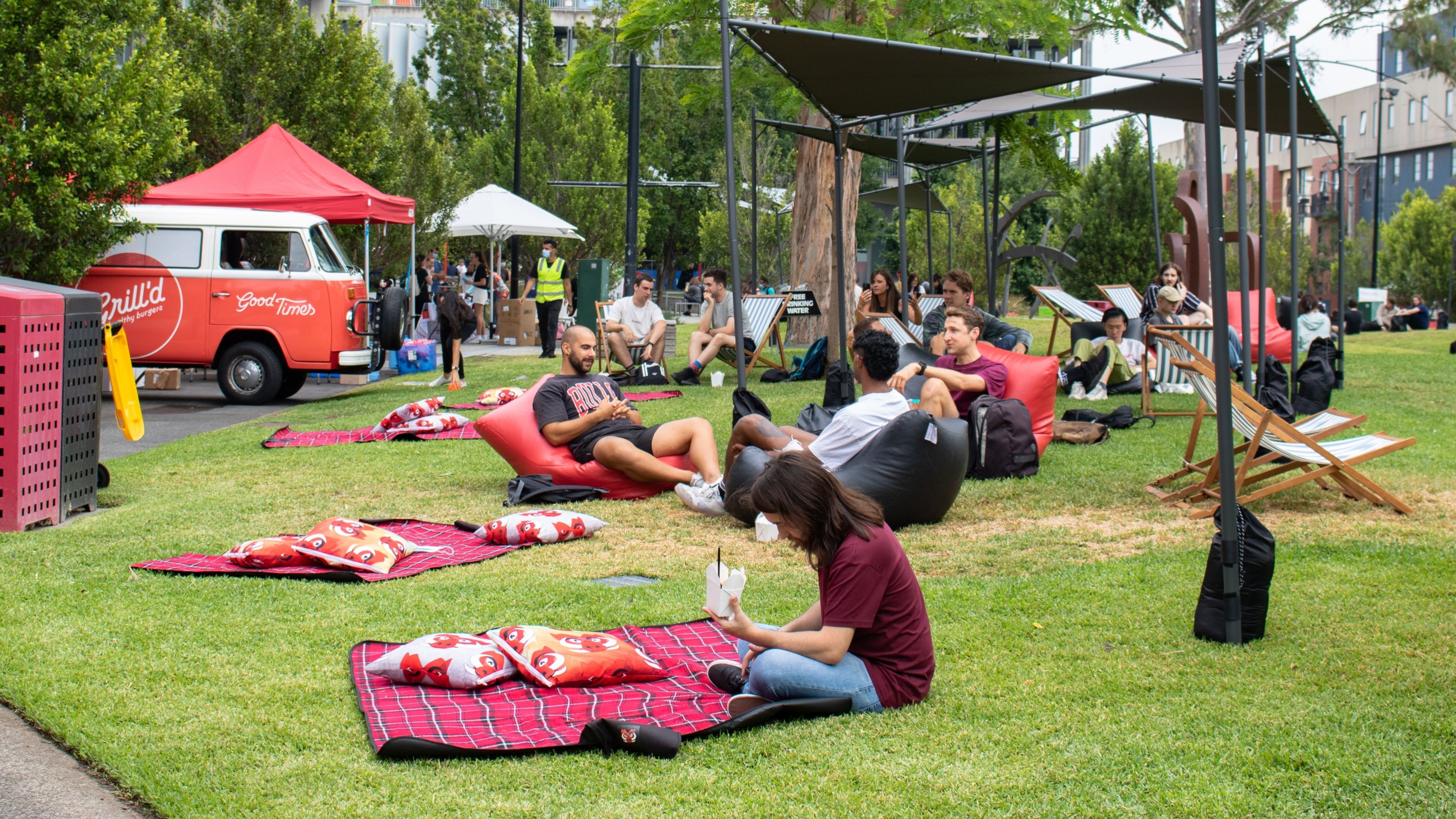Swinburne students relaxing on beanbags and picnic blankets in welcome back week