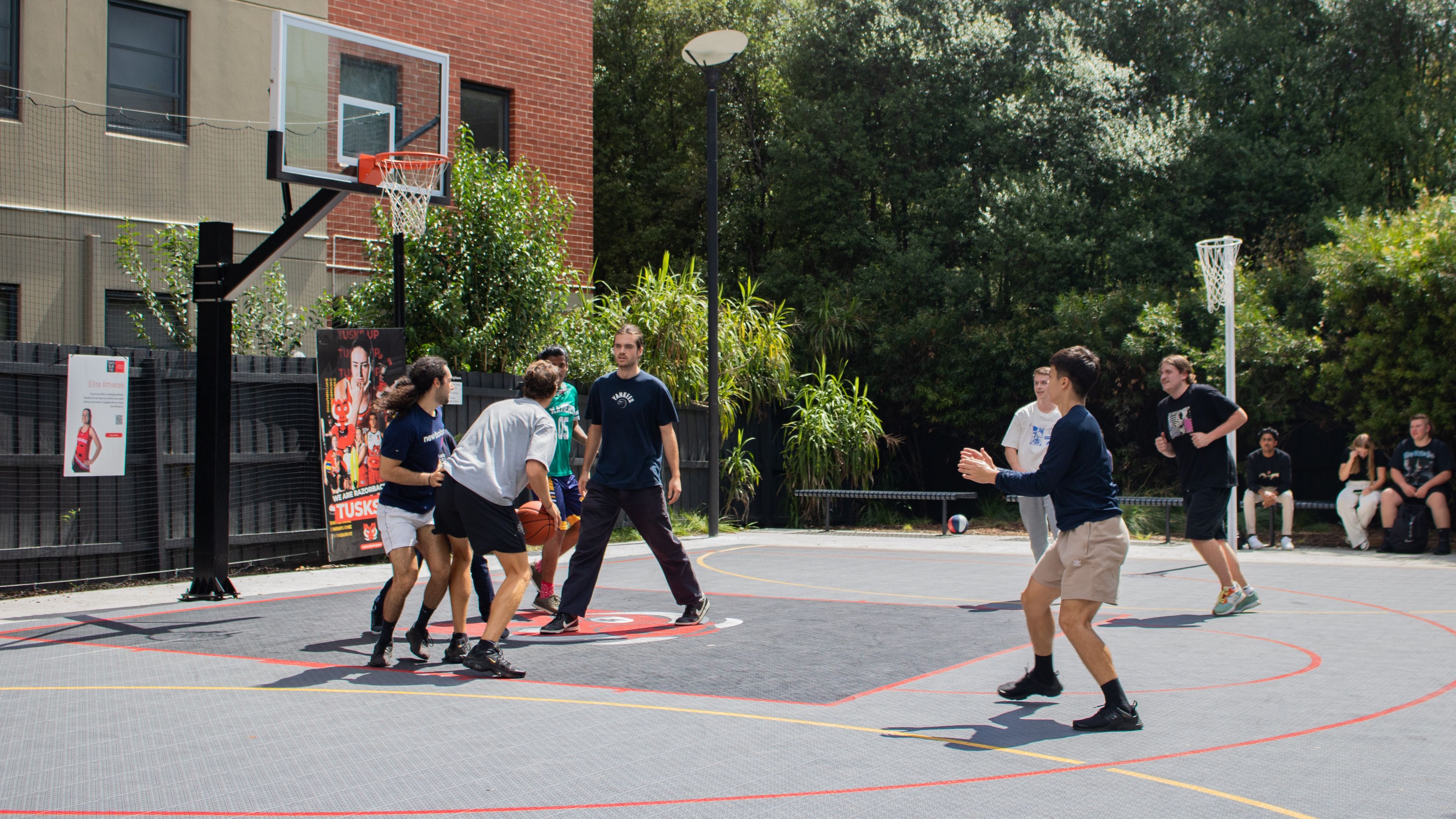 Students play basketball in the new half-court on Hawthorn campus