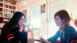 Therapist and patient in deep discussion during a consultation session.