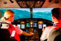 Two professional piloting degree students fly a plane in the aviation flight simulator