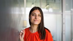 Young college student writing on the chalkboard.