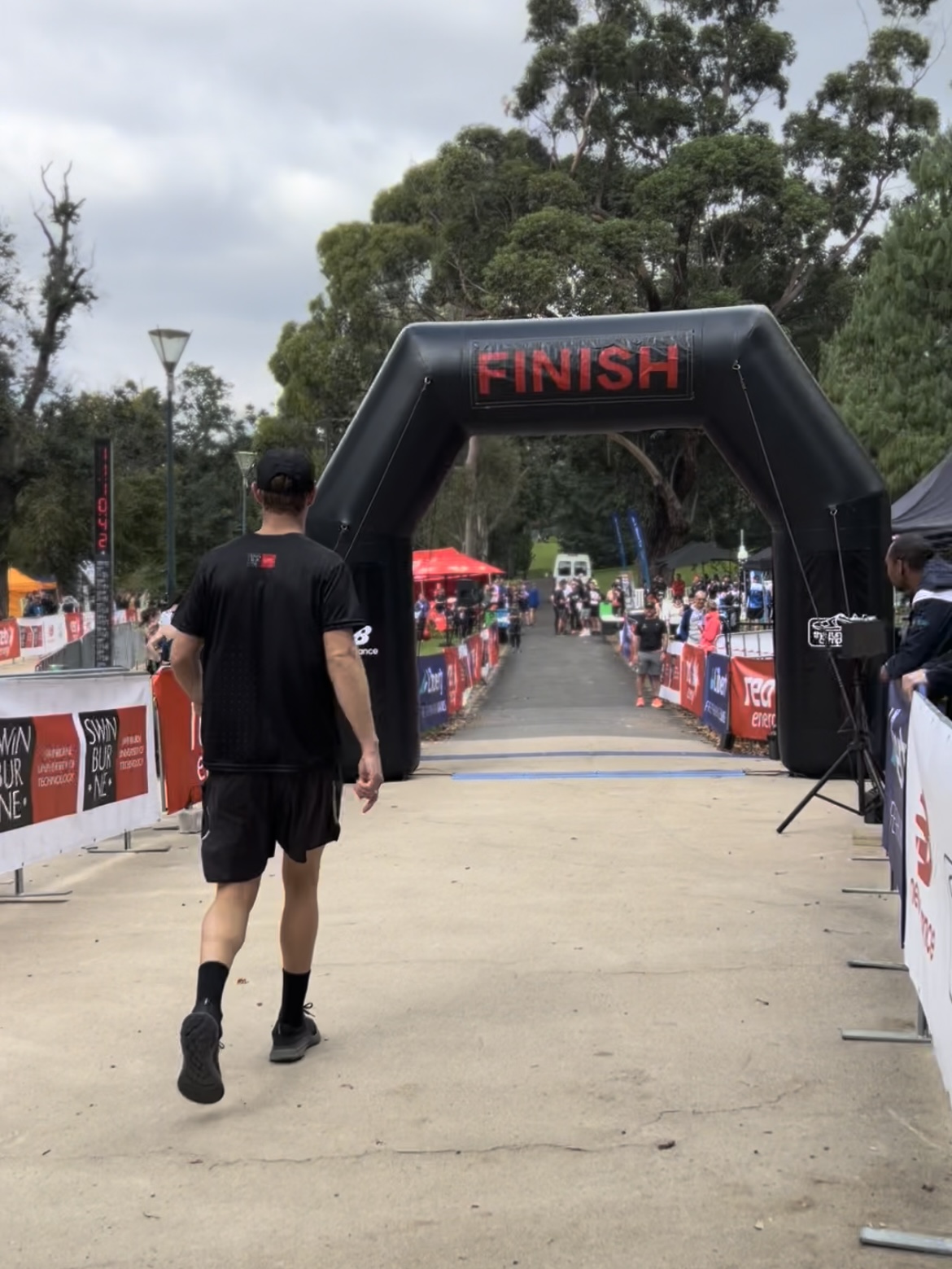 David Astbury walks through the finish line of Run the Tan