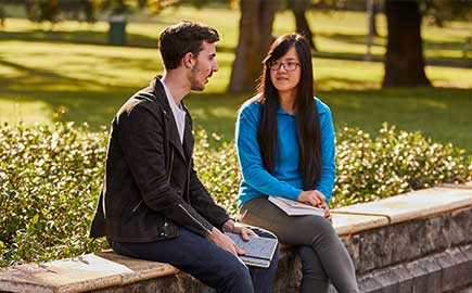 two students talking in central gardens