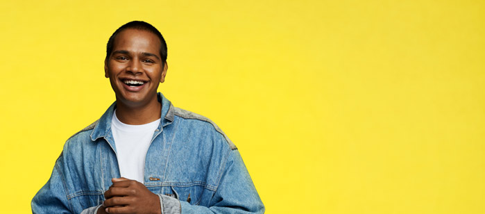 Swinburne student, Joey, smiling and wearing a denim jacket with white t-shirt underneath.